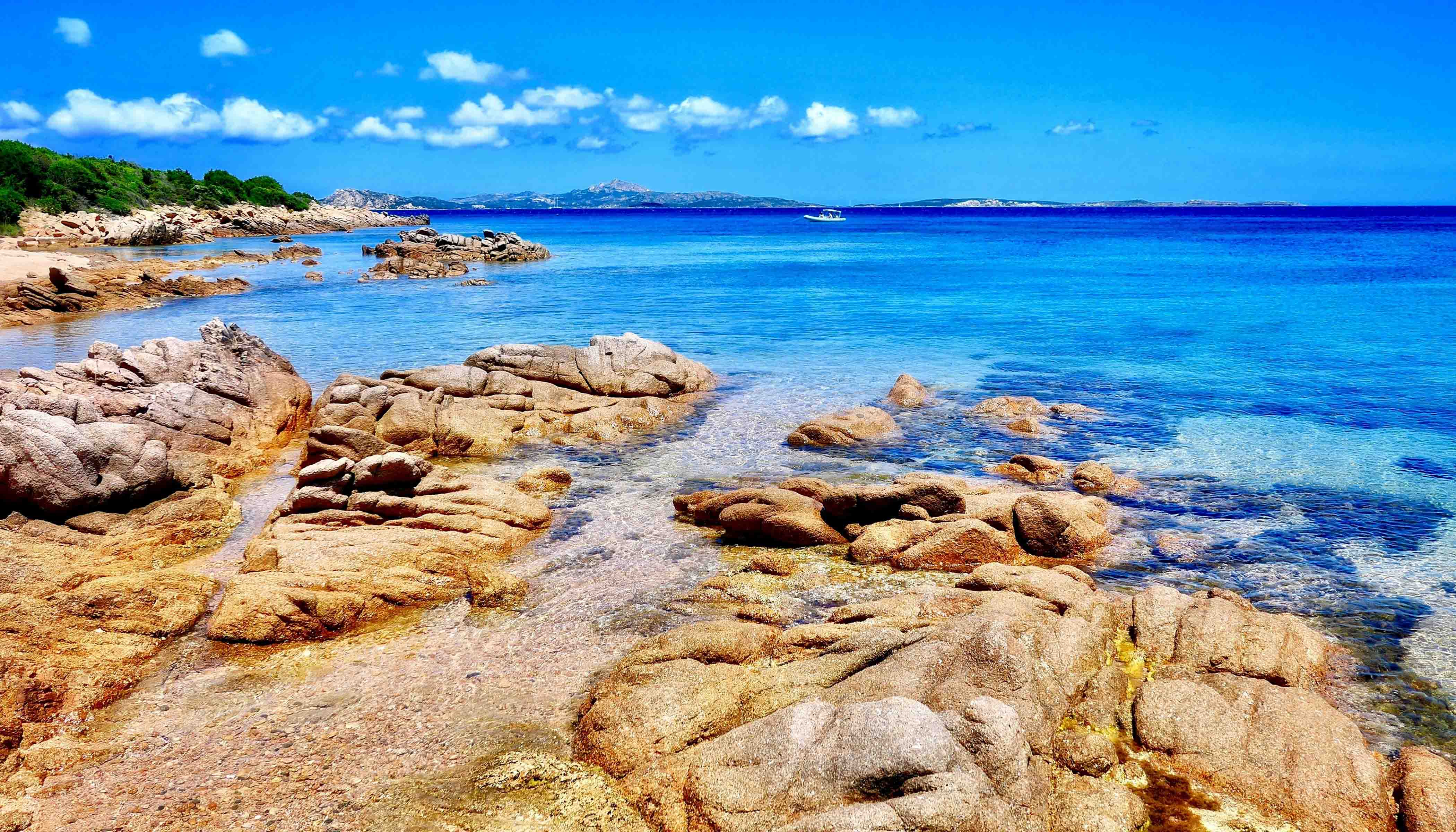 A Rocky Beach With Crystal Clear Blue Ocean