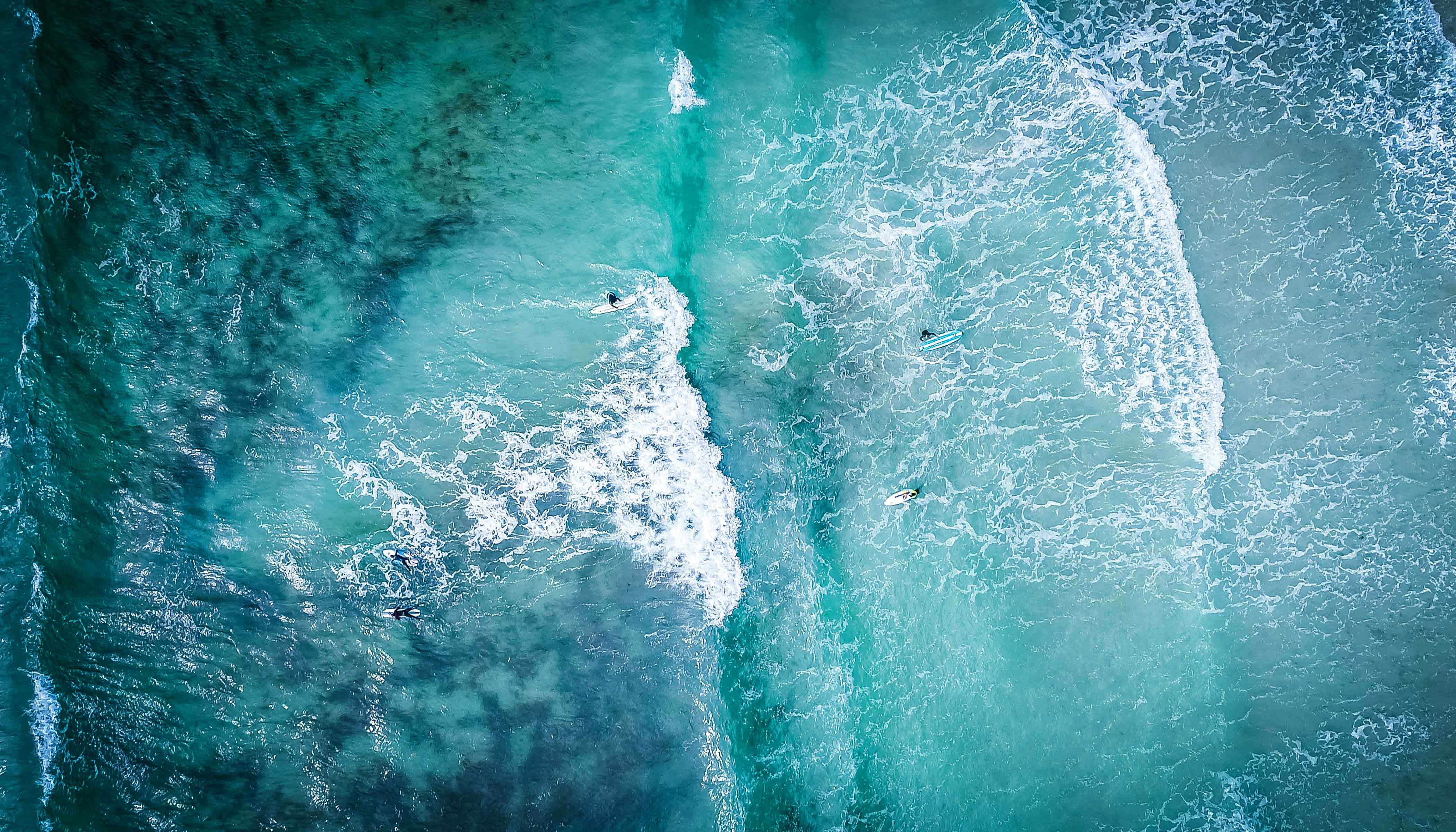 Ariel View of Surfers Surfing in the Ocean