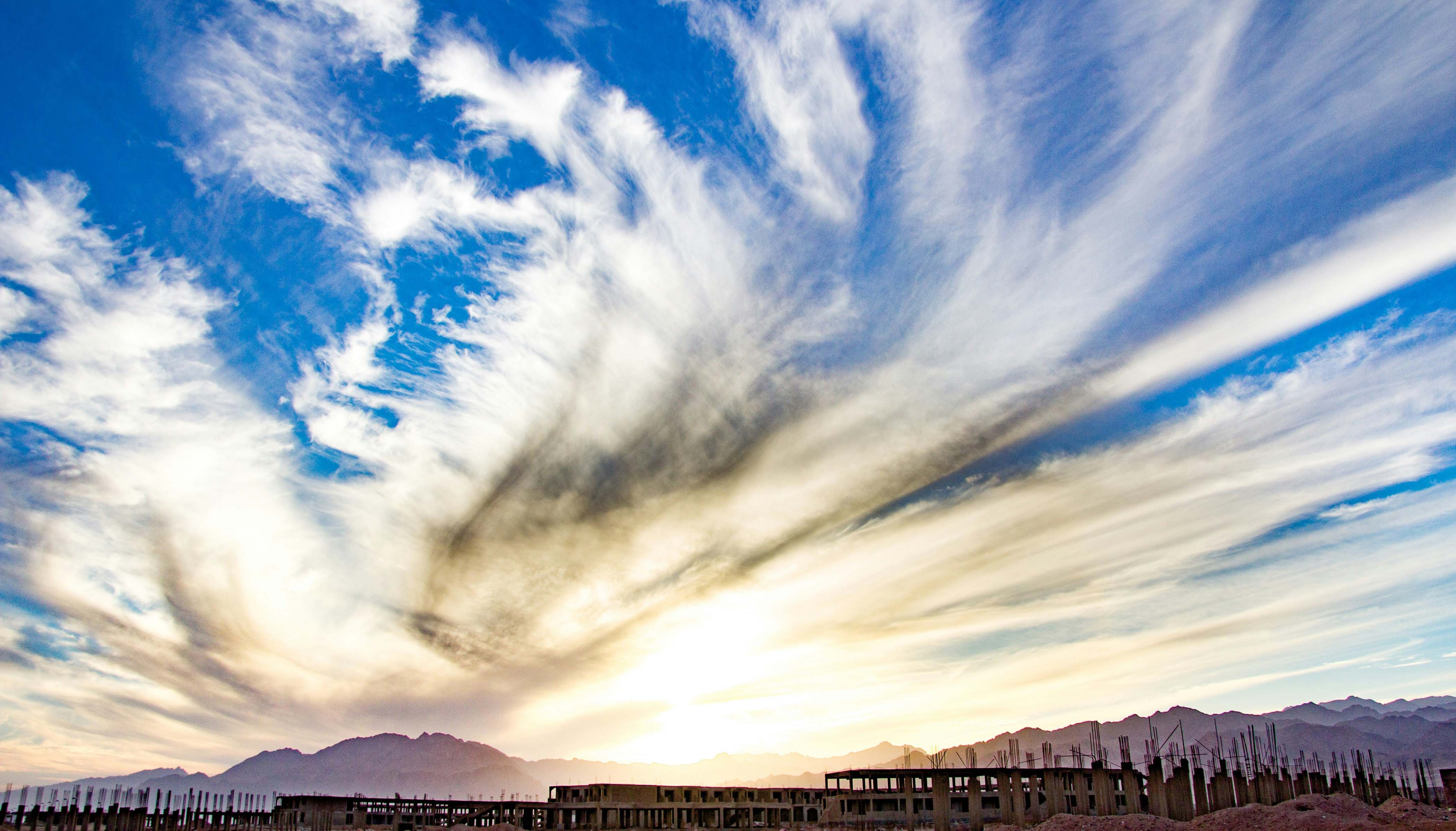 Wispy Clouds Over The Desert